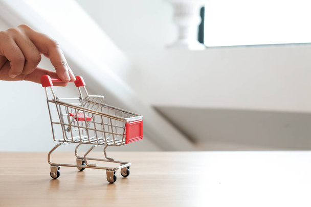Small shopping cart with Laptop for Internet online shopping concept - Photo, Image