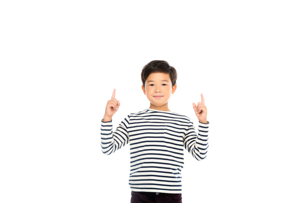 Smiling asian boy pointing with fingers up isolated on white - Photo, Image