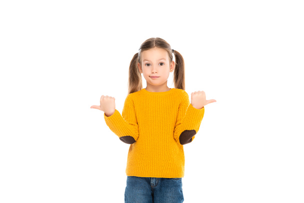Confused kid pointing away while looking at camera isolated on white - Photo, Image