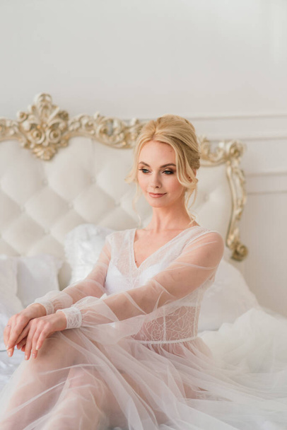 Morning of a beautiful young bride in a boudoir dress. Studio, interior. - Photo, Image