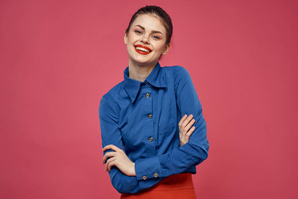 fashionable woman in blue shirt on pink background Red skirt emotions model gesturing with hands cropped view Copy Space - Фото, зображення