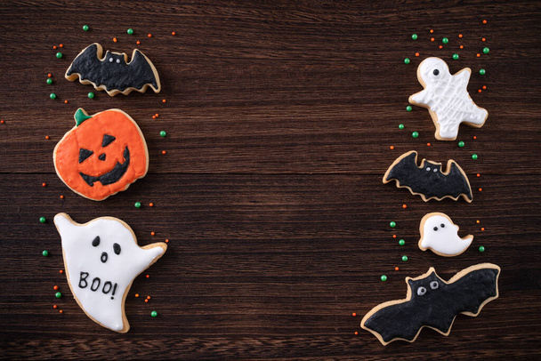 Top view of Halloween festive decorated icing gingerbread sugar cookies with copy space and flat lay layout. - Photo, Image