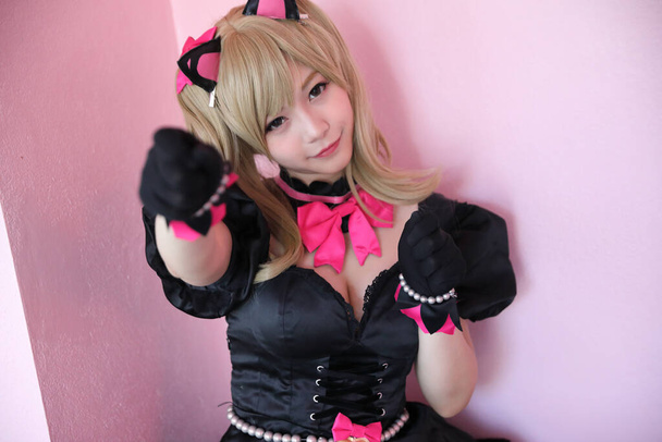 Portrait of game costume girl in pink room background - Photo, Image