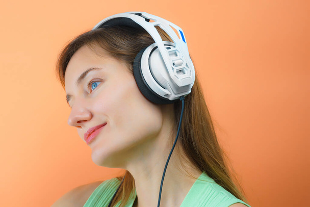 Young dj woman with white headphones. Musical hifi headphones - Fotografie, Obrázek
