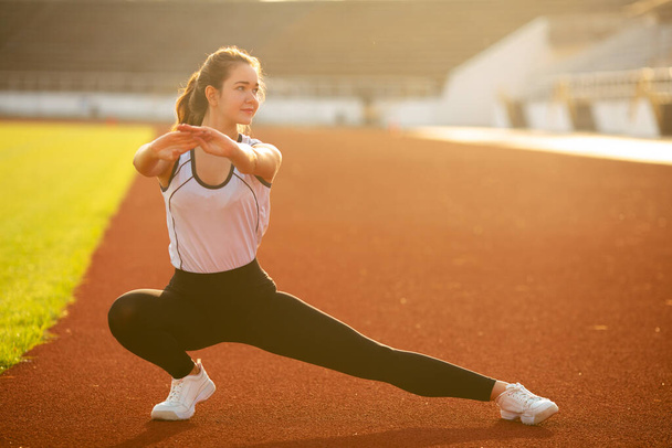 Fitness Girl Doing Leg Workout At Outdoor Stadium - Photo, Image
