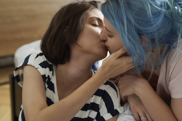 Romantic lesbian couple kissing intimately                                - Фото, зображення