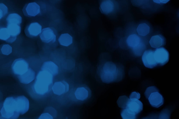 Blurred lights dark blue background. Abstract bokeh with soft light. Shiny festive christmas texture - Foto, imagen