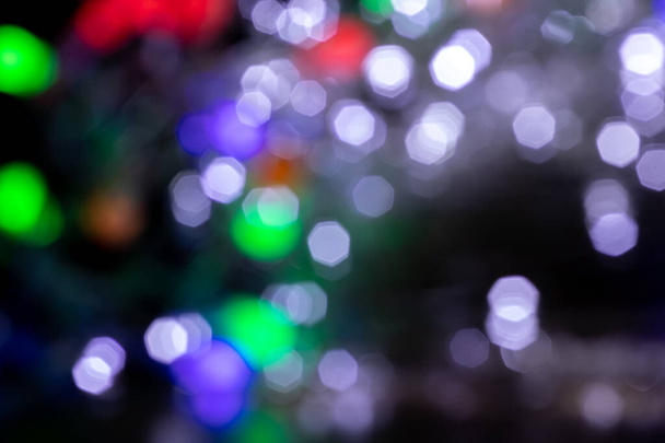 Blurred lights blue, green, red, gray background. Abstract bokeh with soft light. Shiny festive christmas texture - Photo, Image