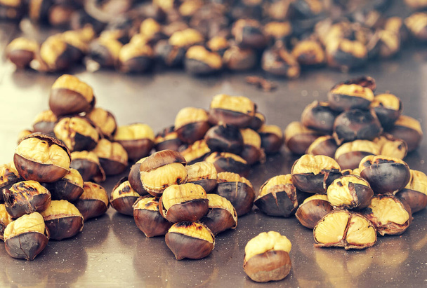 Close-up of fried chestnuts on the street of Istanbul, Turkey. Chestnut is traditional Turkish street food - Fotografie, Obrázek