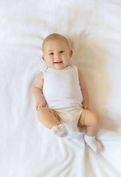 Baby smiles on a white background. Selective focus. People. - Photo, Image