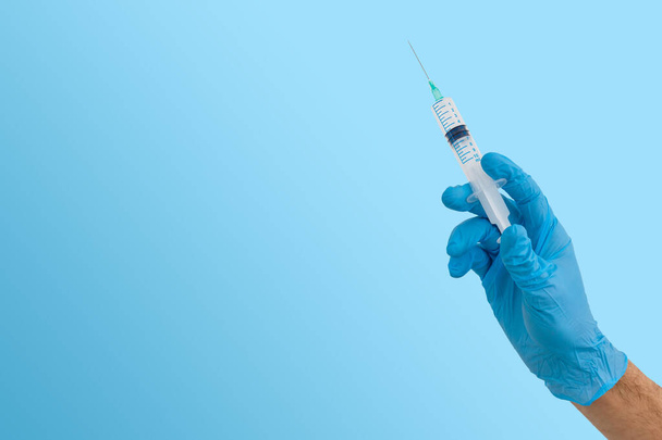Hand holding syringe isolated on white - Photo, Image