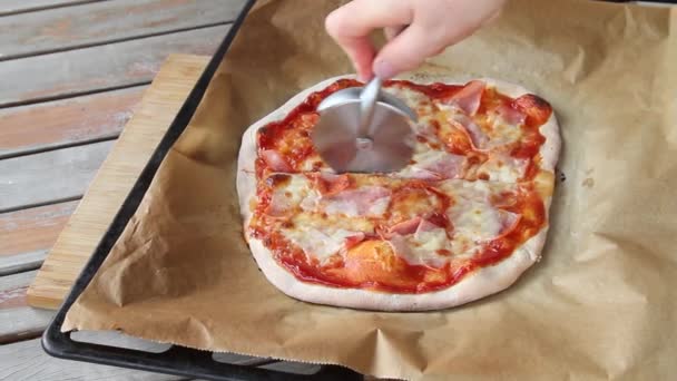 The process of slicing pizza at table . Fresh dough on kitchen table. - Footage, Video