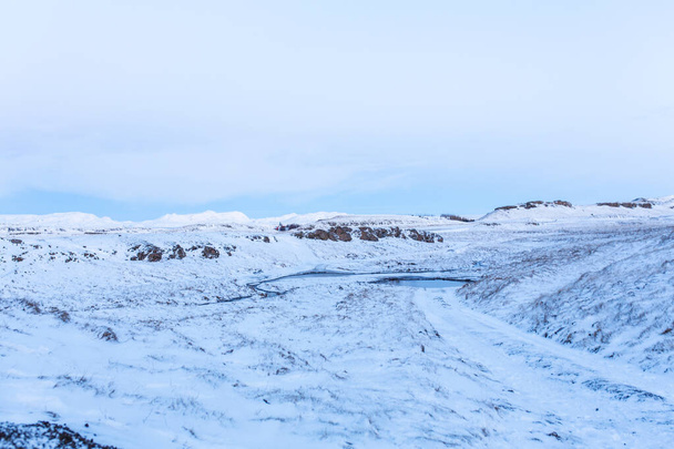 Iceland's incredible fields and plains landscape in winter. The ground is covered with snow. Large spaces. The beauty of winter nature. - Photo, image