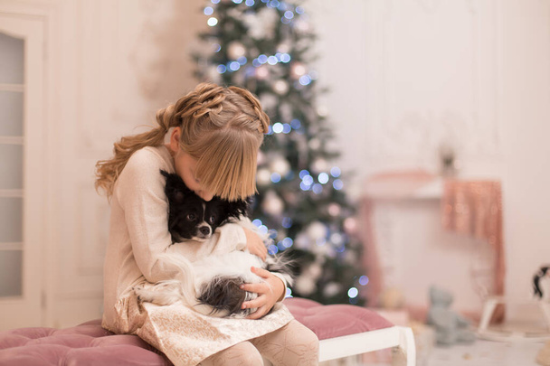 Santa gave the girl a dog for Christmas. Christmas tale. Happy childhood. First pet. - Zdjęcie, obraz