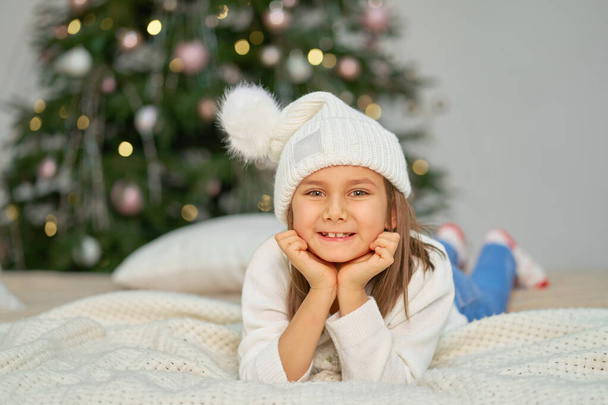 Happy childhood, Christmas magic fairy tale. Little girl waiting for Christmas and holiday gifts - Foto, imagen