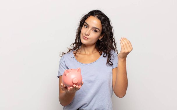 young hispanic woman making capice or money gesture, telling you to pay your debts! - Foto, Imagem