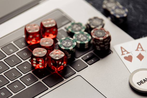 Chips, red dices and playing cards with aces for poker online or casino gambling close-up. Online casino concept - Photo, Image