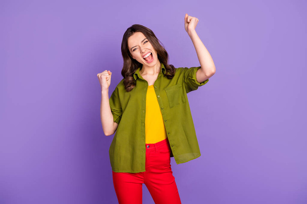 Portrait of ecstatic crazy girl celebrate lottery win raise fists scream yeah wear good look clothes isolated over vivid purple color background - Foto, Bild