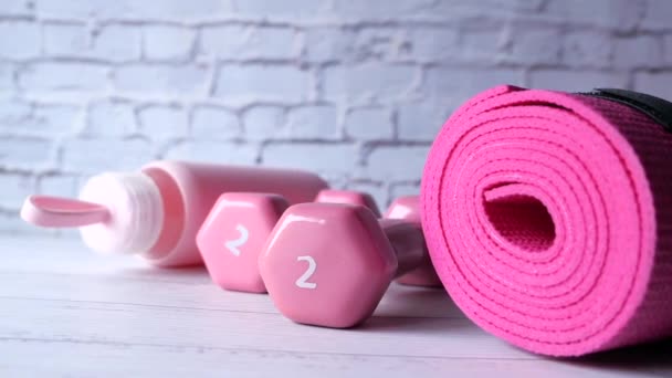  Kurzhantel in rosa Farbe, Trainingsmatte und Wasserflasche auf weißem Hintergrund  - Filmmaterial, Video