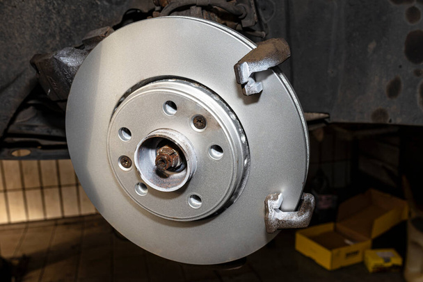 New brake disc with an anti-corrosion layer, mounted on the front hub. - Photo, Image
