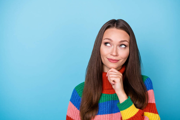Portrait of minded girl look copyspace touch fingers chin think thoughts decide decision choose choice solution wear rainbow style jumper isolated over blue color background - Foto, imagen