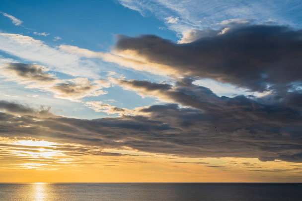 Korai napkelte és epikus felhős ég a sziklás tengerparton Torrevieja, Alicante, Spanyolország. Földközi-tenger 2019. - Fotó, kép
