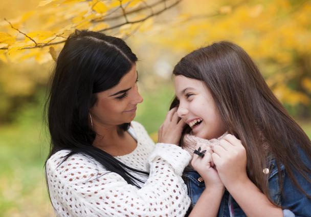 Mother and daughter are having fun in autum nature - Foto, imagen