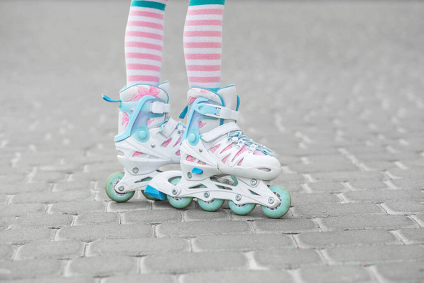 The child learns to roller skate. Childhood and hobby concept. - Photo, Image