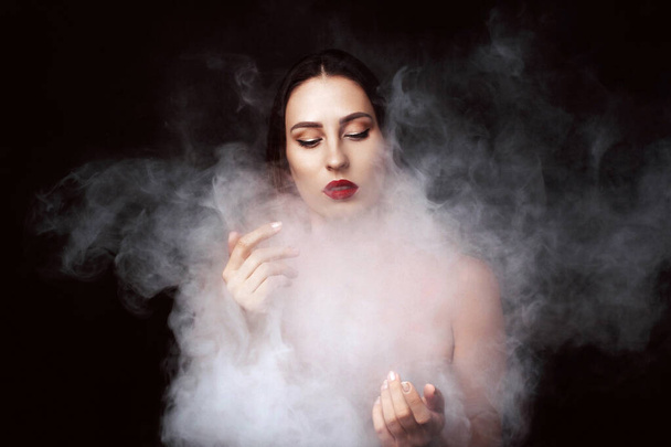Attractive young girl and white smoke. - Zdjęcie, obraz