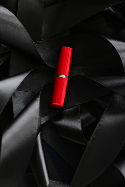 Red lipstick on black silk background, luxury make-up and beauty cosmetic - Photo, Image