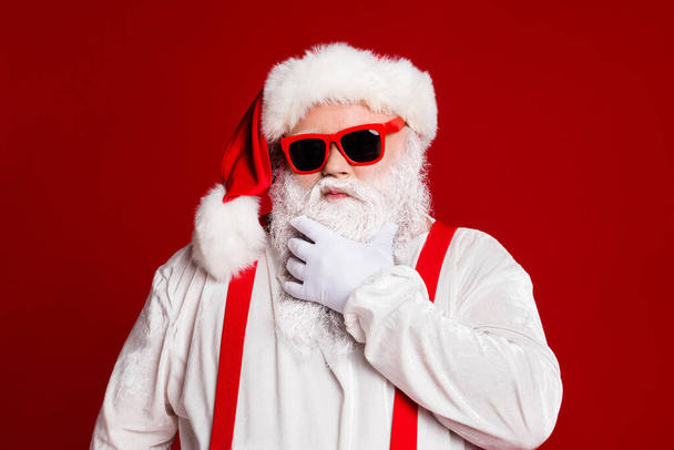 Close-up portrait of his he attractive confident naughty arrogant white-haired Santa father touching beard thinking isolated over bright vivid shine vibrant red burgundy maroon color background - Fotó, kép