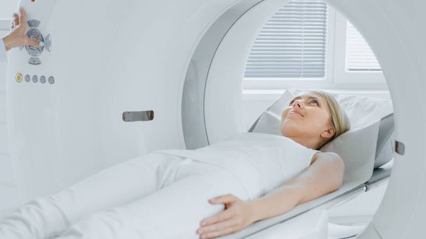In Medical Laboratory Radiologist Controls MRI or CT or PET Scan with Female Patient Undergoing Procedure. High-Tech Modern Medical Equipment. Friendly Doctor Chats with Patient. - Foto, Imagem