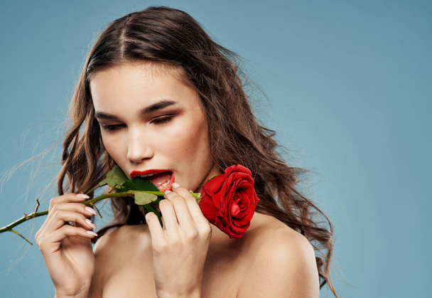 Passionate woman with red rose eye shadow on eyelids blue background cropped view - Photo, Image