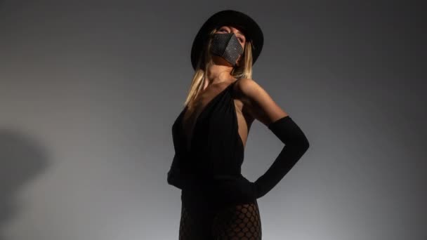 Young woman wearing sparkly face mask and top hat - Footage, Video