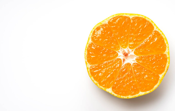 Cut Japanese early maturing mandarin oranges on a white background - Zdjęcie, obraz