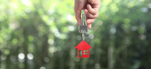 Real estate agent handing over a house keys in hand, and coins - Photo, Image