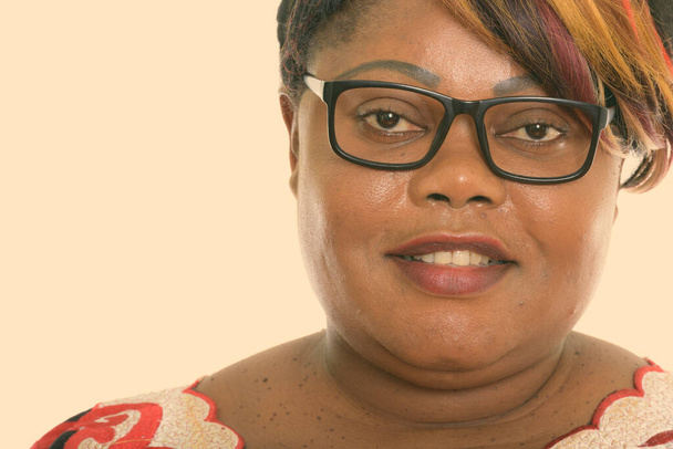 Close up of happy fat black African woman smiling while wearing eyeglasses - Photo, Image