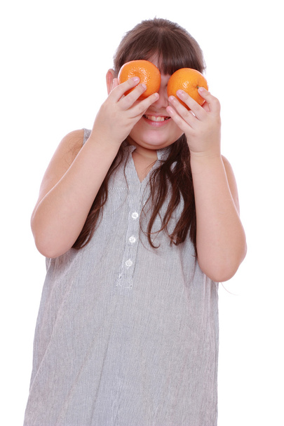Girl holding mandarins on white background - Fotografie, Obrázek