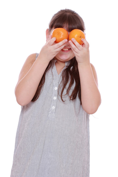 Girl holding mandarins on white background - 写真・画像