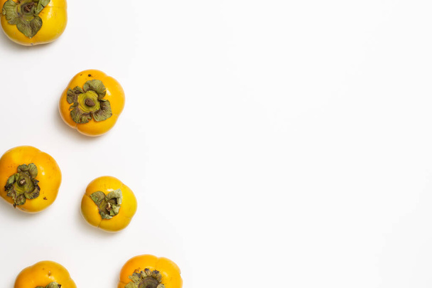 Sweet persimmon fruit on white background. flat lay, top view, copy space - Φωτογραφία, εικόνα