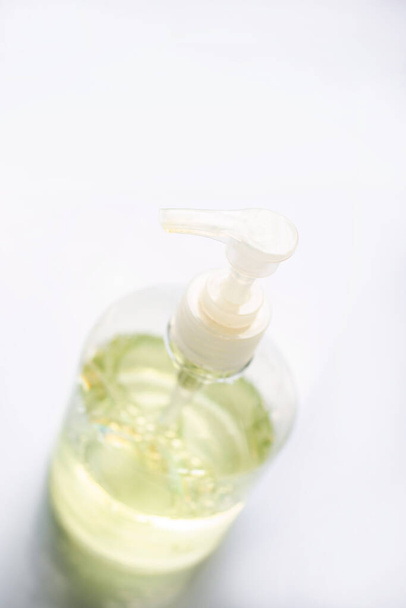 A bottle of hand sanitizer is isolated on a white background. - Foto, afbeelding