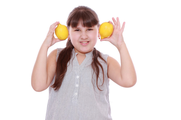 Girl with fresh yellow lemons - Фото, зображення
