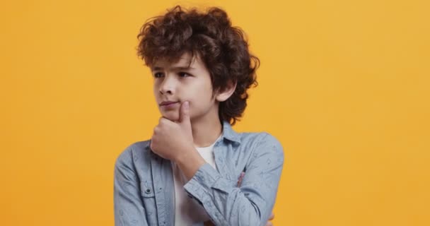 Kids fantasy and creativity concept. Adorable pensive boy thinking, feeling inspired and got incredible idea - Footage, Video