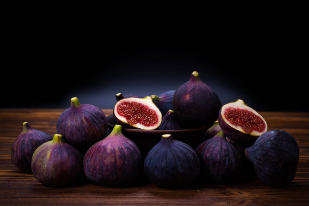 Tasty figs on a black background. Top view. Slices. - Photo, Image