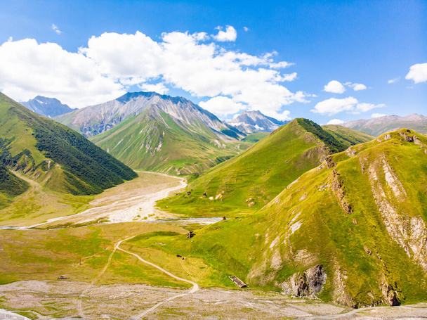 Panoramic views of green caucasus mountains and old tower ruins of ancient towers. Georgia and Russia boder mountains pass in Truso valley. - Photo, Image