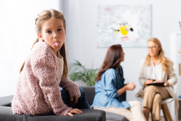 daughter fooling around while mother talking to psychologist - Photo, Image
