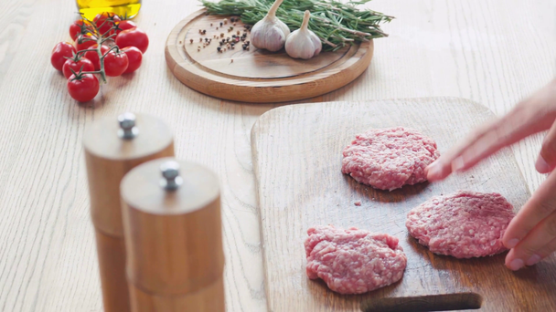vista recortada del chef formando empanada de carne picada en la tabla de cortar cerca de los ingredientes - Imágenes, Vídeo