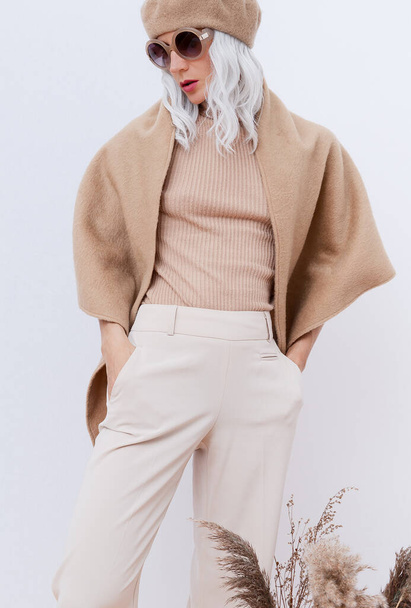Fashion photo of young beautiful lady in beige clothes on white background. Beige aesthetics. Fashion look book. Warm Fall Winter trends. - Φωτογραφία, εικόνα