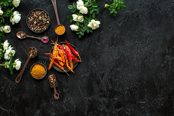 Set of hot Indian spices with flowers, top view - Foto, imagen