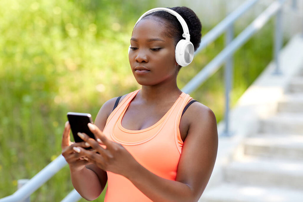 african american woman with headphones and phone - Photo, image